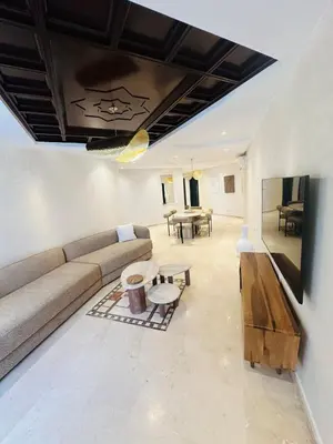 a living room with a couch and a table at Sublime 2 bedrooms with pool and Wi-Fi Marrakech in Marrakech