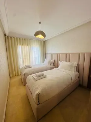 a hotel room with two beds and a window at Sublime 2 bedrooms with pool and Wi-Fi Marrakech in Marrakech