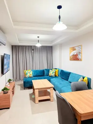 a living room with a blue couch and a table at A21 Moderne Confort Au Cœur De Marrakech in Marrakech