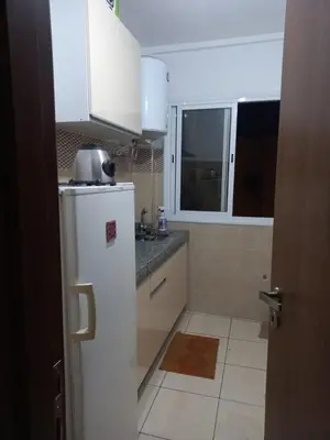 a kitchen with a white refrigerator and a window at Appartement au centre de marrakech in Marrakech
