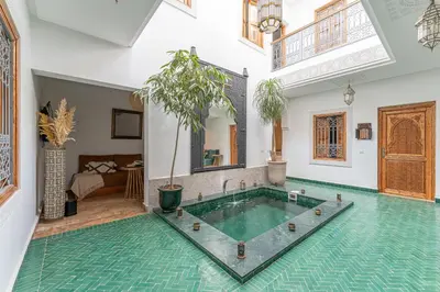 a swimming pool in a room with a pool at Riad OM SAADENE in Marrakech