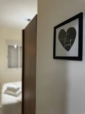 a bedroom with a picture of a heart on the wall at Modern Apartment Near Airport in Marrakech