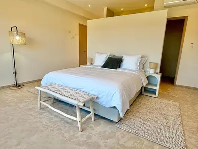 a bedroom with a large white bed and a table at Palais Kenza in Marrakech