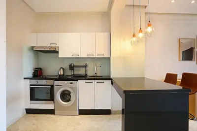 a kitchen with a washing machine and a stove at New Elegant and cozy appartement next to carre eden in Marrakech