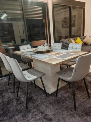 a dining room with a large wooden table and chairs at Luxury Apartment in Marrakech Premium Village 5 Pools free Parking in Marrakech