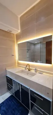 a bathroom with a sink and a large mirror at Luxury Apartment in Marrakech Premium Village 5 Pools free Parking in Marrakech