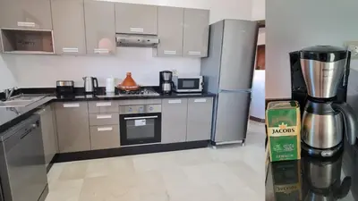 a kitchen with a refrigerator and a coffee maker at Luxury Apartment in Marrakech Premium Village 5 Pools free Parking in Marrakech