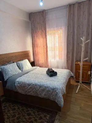 a bedroom with a bed with a bag on it at Julie Airport Boarding Apartment in Marrakech