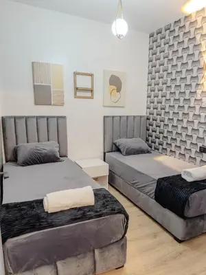 a bedroom with two beds and a couch at Cozy Apt Close to Gueliz Medina in Marrakech
