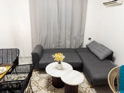 a living room with a couch and a table at Cozy Apt Close to Gueliz Medina in Marrakech