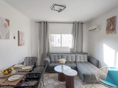a living room with a couch and a table at Cozy Apt Close to Gueliz Medina in Marrakech