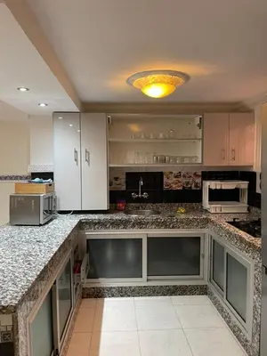 a large kitchen with marble counter tops and appliances at Riad Malika et Cristina in Marrakech