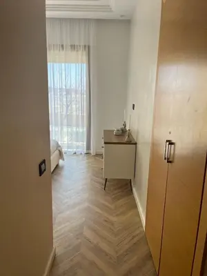 a room with a hallway with a desk and a window at Appartement le vizir center in Dar Caïd Layadi