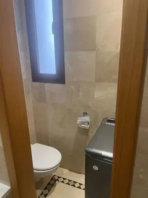 a bathroom with a toilet and a window on the wall at Appartement le vizir center in Dar Caïd Layadi