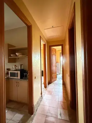 a hallway in a house with a kitchen at 2 bedroom palmeraie, pools & 3 terraces in Marrakech
