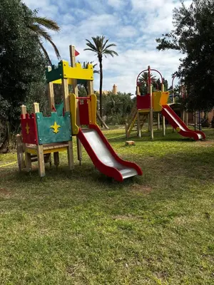 a playground with a slide in a park at 2 bedroom palmeraie, pools & 3 terraces in Marrakech