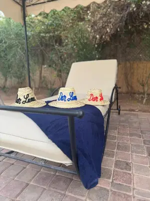 a table with hats sitting on top of a chair at Splendide Villa avec piscine in Marrakech