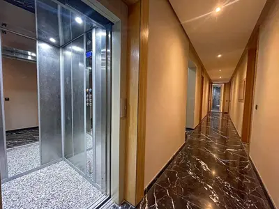 an empty hallway with a glass elevator in a building at High-End Cozy and Modern Studio in Marrakech