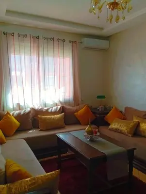 a living room with a couch and a coffee table at Appartement calme et spacieux pour famille in Marrakech