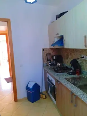 a kitchen with a sink and a stove top oven at Appartement calme et spacieux pour famille in Marrakech