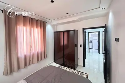 a room with a bed and a glass door at Stylish & Cozy Apartment in Marrakech in Marrakech