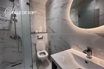 a bathroom with a sink and a toilet and a mirror at Stylish & Cozy Apartment in Marrakech in Marrakech