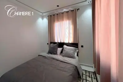 a small bedroom with a bed with a window at Stylish & Cozy Apartment in Marrakech in Marrakech