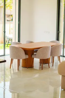 a wooden table and chairs in a room at Villa Emeraude 15 minutes du centre in Marrakech
