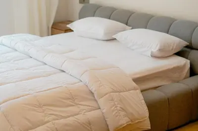a large bed with white sheets and pillows on it at Villa Emeraude 15 minutes du centre in Marrakech