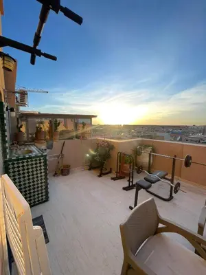 a balcony with chairs and a view of the city at Sultana in Marrakech
