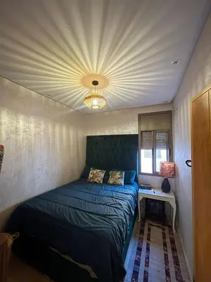 a bedroom with a blue bed with a ceiling at Sultana in Marrakech