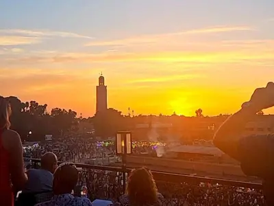 a group of people taking a picture of the sunset at Sultana in Marrakech