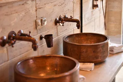 a copper sink and faucet on a counter at Luxury Resort Loudi Marrakech in Marrakech