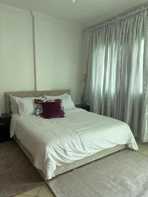 a bed with white sheets and pillows in a bedroom at BELDI and contemporary elegance in Marrakech