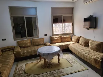 a living room with two couches and a tv at Maison D'hôte Dar ALBIDAWI CH5 in Marrakech