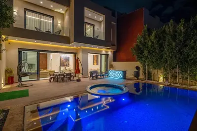 a house with a swimming pool in front of a house at Villa cancun resort Luxury Spa-cinéma & jacuzzi in Marrakech