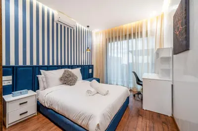 a small bedroom with a bed and a desk at Villa cancun resort Luxury Spa-cinéma & jacuzzi in Marrakech