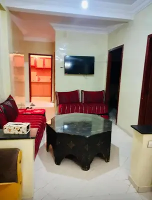 a living room with a red couch and a coffee table at Modern 2bedroom full furnished in downtown in Marrakech