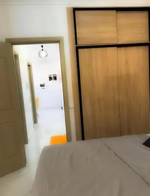 a bedroom with a bed and a closet and a door at marrakech geliz in Marrakech