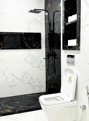 a bathroom with a white toilet and a shower at marrakech geliz in Marrakech
