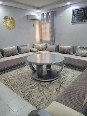 a living room with a couch and a glass table at japoniya in Marrakech