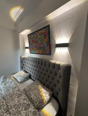 a bedroom with a couch and a painting on the wall at Elegant Apartment Marrakech in Marrakech