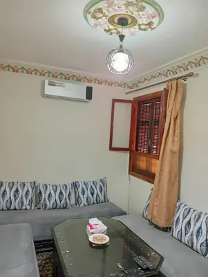 a living room with a couch and a table at Mhamid airport in Marrakech