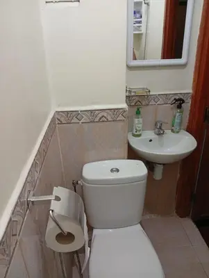 a bathroom with a white toilet and a sink at Mhamid airport in Marrakech