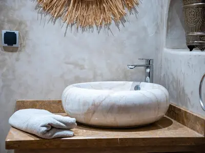 a bathroom with a large white tub on a table at Dar LalaFadma-Pvt 1BR Studio-1min to Bahia Palace in Marrakech