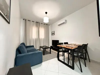 a living room with a blue couch and a table at Budget-Friendly 2BR - AC and heating in All Rooms in Marrakech