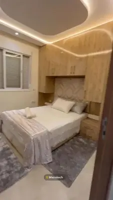 a bedroom with a bed in a room with a ceiling at Appartement in Marrakech