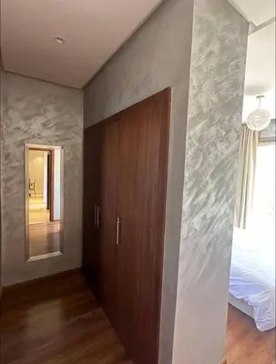 a room with a door and a bed and a mirror at Prestigia Jubaea Marrakech Argane in Marrakech