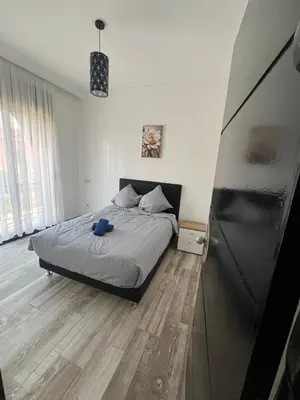 a bedroom with a bed with a blue object on it at VILLA aVEC PISCINE CHAUFFÉE in Marrakech