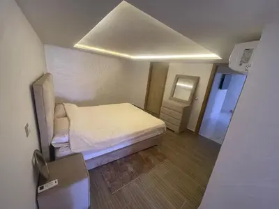 a small bedroom with a bed and a mirror at Cosy appartement downtown gueliz in Marrakech